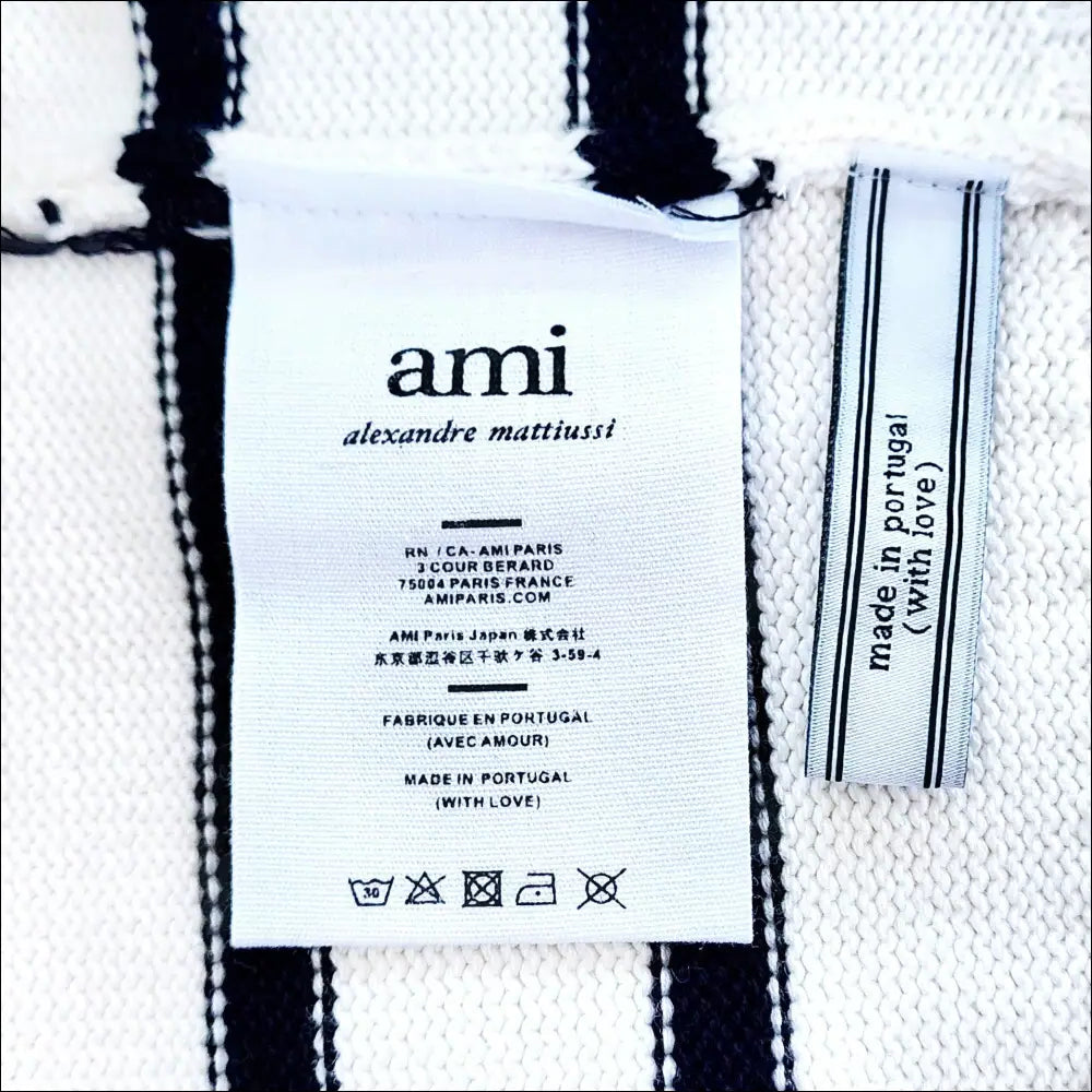 AMI Logo Cardigan label showing care instructions and origin, featuring Ami Logo in elegant design.