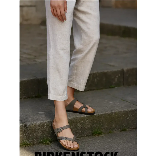 Birkenstock Mayari sandals in stone Birko-Flor worn casually with linen pants on outdoor steps.