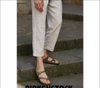 Birkenstock Mayari sandals in stone Birko-Flor worn casually with linen pants on outdoor steps.