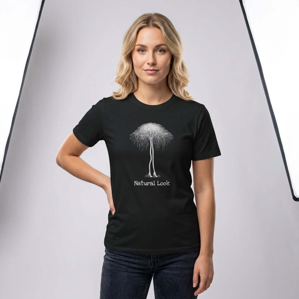 Birch Trees in Heels – Surrealism Art Tee featuring a woman in a black shirt with a tree design and 'Natural Look' text.
