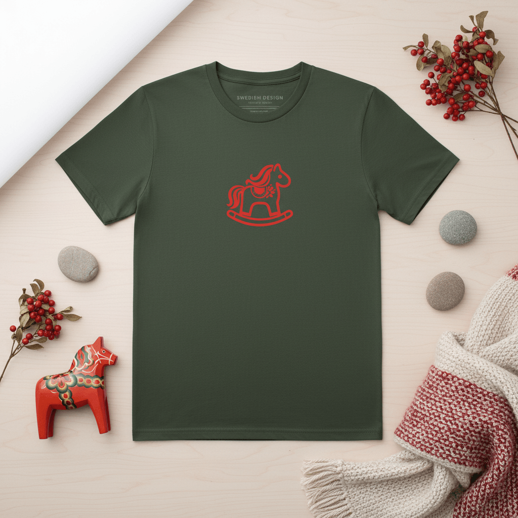 Dalarna Red Rocking Horse T-shirt on a green background with decorative elements.