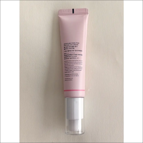 Medicube Eye Cream – PDRN Peptide in a pink tube, designed for nourishing and rejuvenating the eye area, 30 ml.
