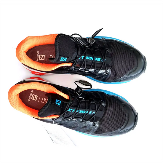 Salomon XT-Wings 2 sneakers in black and orange, showcasing technical design and comfort for trail running.