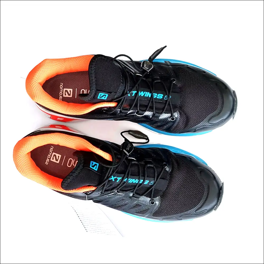 Salomon XT-Wings 2 sneakers in black and orange, showcasing technical design and comfort for trail running.